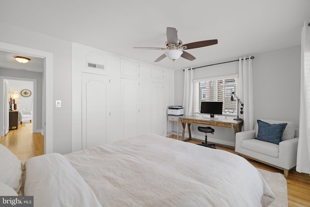 bedroom featuring a closet, ceiling fan, and light hardwood / wood-style flooring