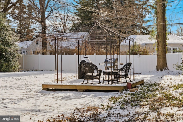 yard covered in snow featuring a wooden deck