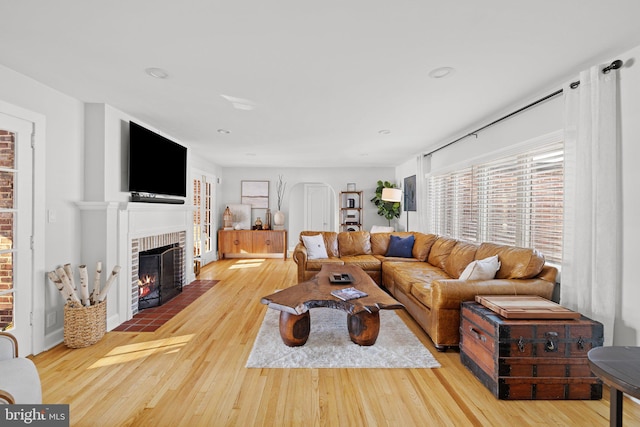 living room featuring light hardwood / wood-style floors and a fireplace