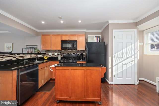 kitchen with dark hardwood / wood-style floors, sink, decorative backsplash, a center island, and black appliances