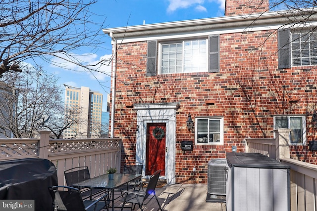 rear view of property featuring cooling unit and a patio area