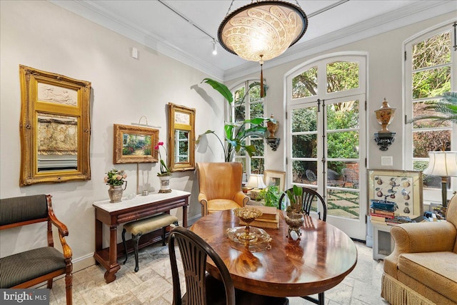 living area featuring an inviting chandelier and ornamental molding