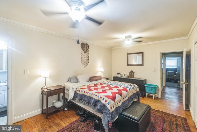 bedroom featuring crown molding, wood-type flooring, sink, and ceiling fan