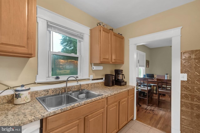 kitchen with sink, a wealth of natural light, and light tile patterned floors