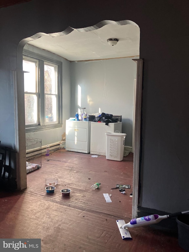 interior space featuring wood-type flooring and washing machine and clothes dryer