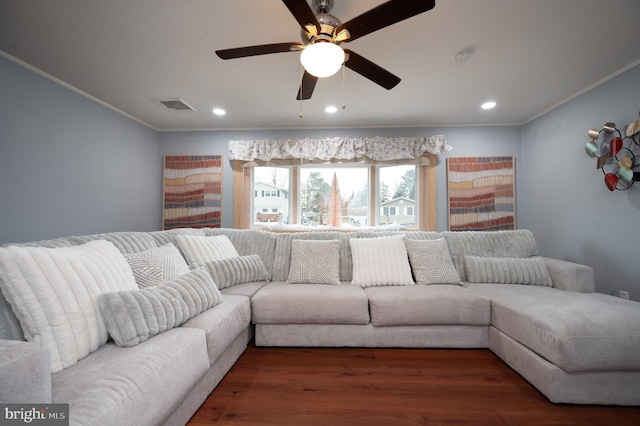 living room featuring dark hardwood / wood-style flooring, ornamental molding, and ceiling fan