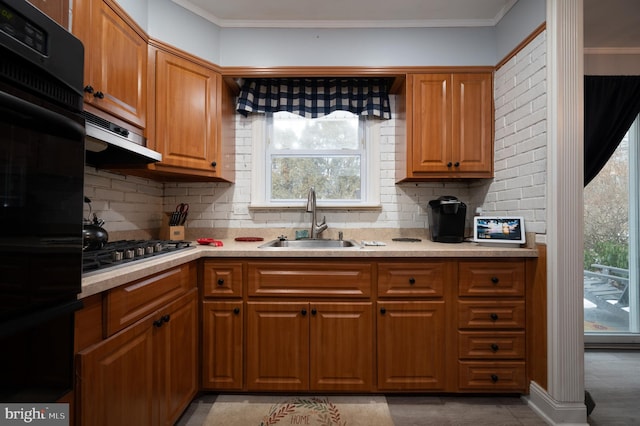 kitchen with double oven, stainless steel gas stovetop, tasteful backsplash, and sink