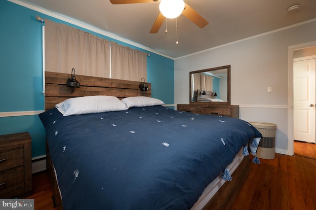 bedroom with dark hardwood / wood-style flooring, a baseboard heating unit, ceiling fan, and crown molding