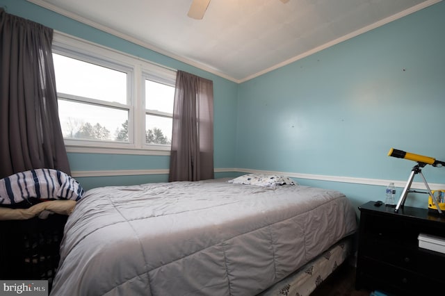 bedroom with ornamental molding and ceiling fan