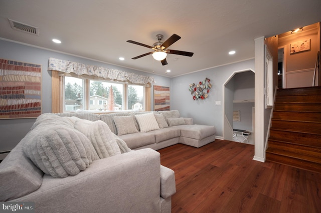 living room featuring ceiling fan, dark wood-type flooring, and crown molding