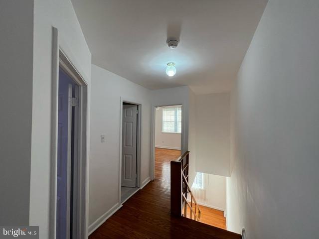 corridor featuring dark wood-type flooring