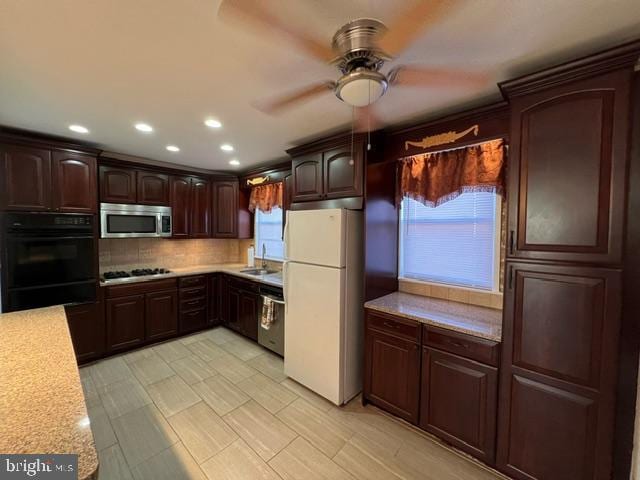 kitchen featuring ceiling fan, a wealth of natural light, sink, and appliances with stainless steel finishes