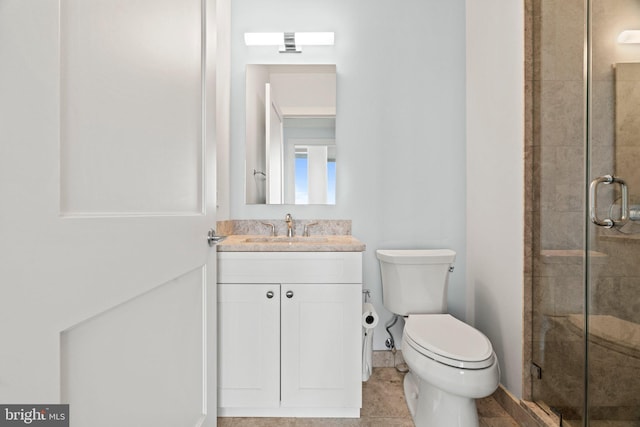 bathroom with walk in shower, vanity, and toilet