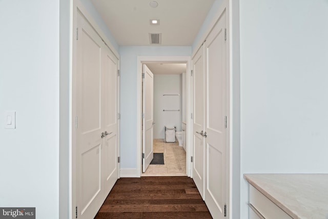 corridor with dark hardwood / wood-style floors