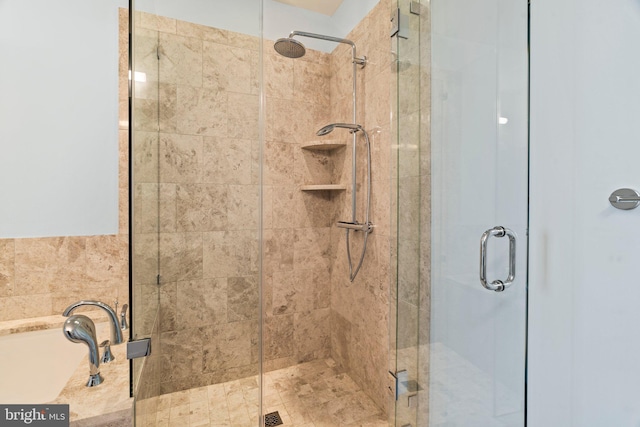 bathroom featuring a shower with shower door