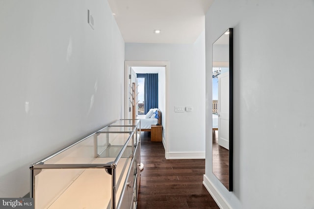 corridor with dark hardwood / wood-style flooring