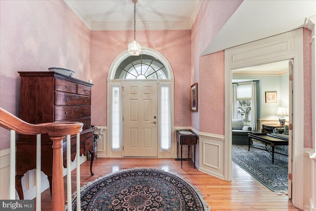 foyer featuring light hardwood / wood-style flooring and ornamental molding