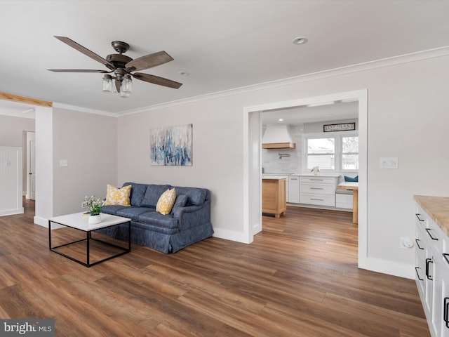 living room featuring ceiling fan, dark hardwood / wood-style flooring, and crown molding