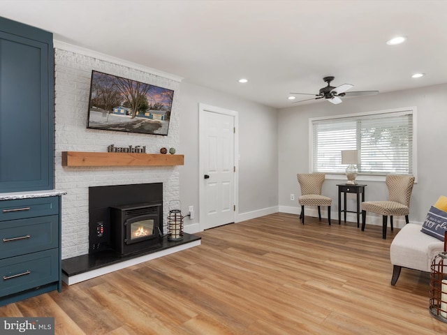 sitting room featuring light hardwood / wood-style floors and ceiling fan