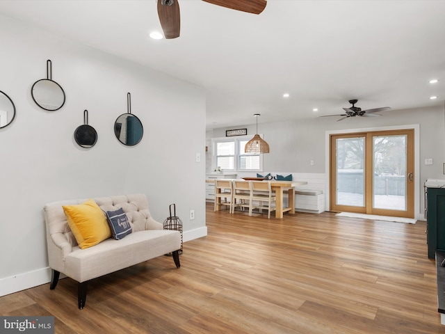 living area featuring ceiling fan and light wood-type flooring