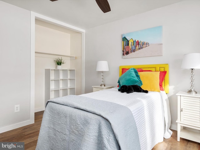 bedroom featuring ceiling fan and dark wood-type flooring