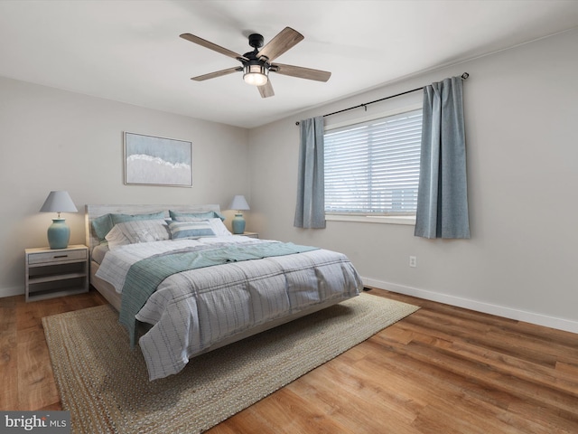 bedroom with hardwood / wood-style flooring and ceiling fan