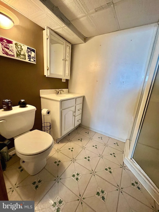 bathroom featuring vanity, toilet, and walk in shower