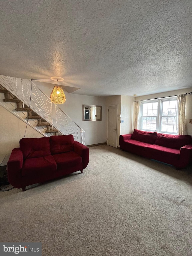 carpeted living room featuring a textured ceiling and a wall mounted AC