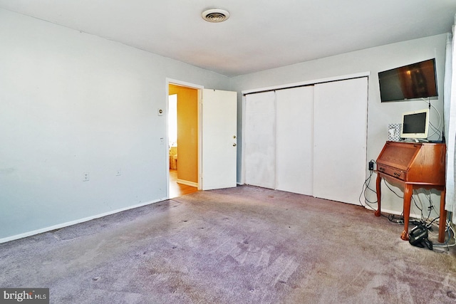 unfurnished bedroom with carpet and a closet