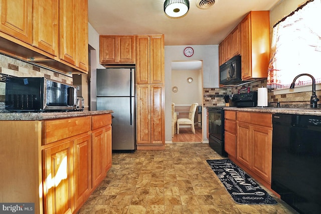 kitchen with black appliances, sink, and tasteful backsplash