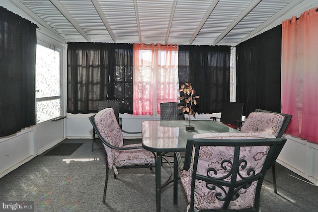 dining room featuring dark colored carpet