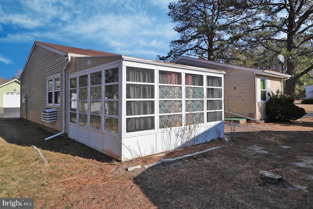 view of side of property with a sunroom