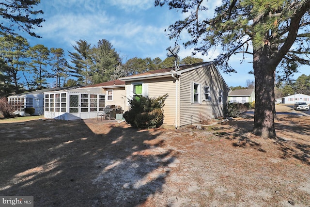 rear view of property with a sunroom