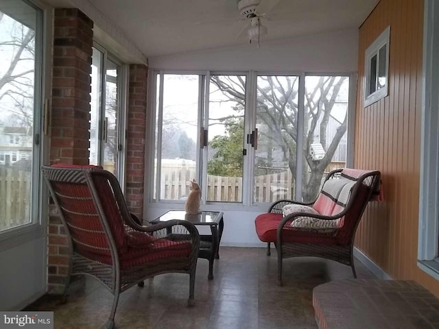 sunroom / solarium with ceiling fan and lofted ceiling