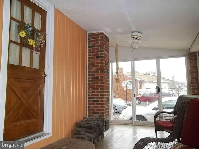 sunroom / solarium with ceiling fan and vaulted ceiling