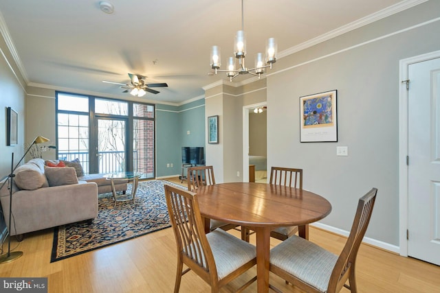 dining room featuring crown molding, light hardwood / wood-style floors, and ceiling fan with notable chandelier