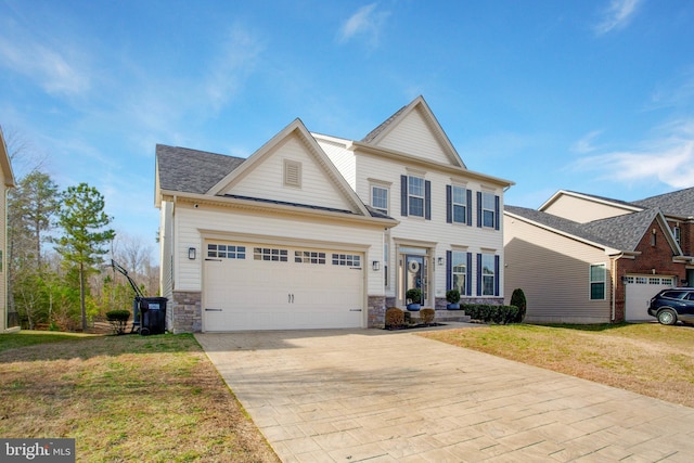 view of front of home featuring a garage and a front lawn