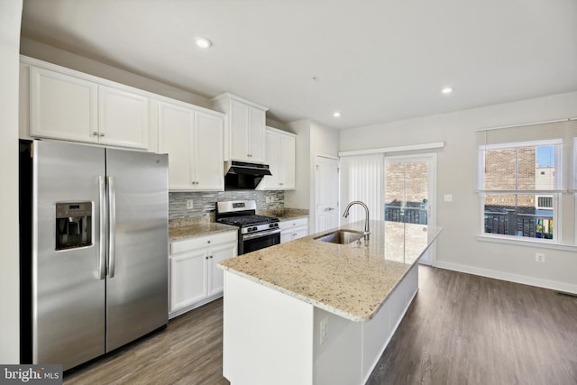 kitchen with white cabinetry, a center island with sink, stainless steel appliances, dark hardwood / wood-style flooring, and sink