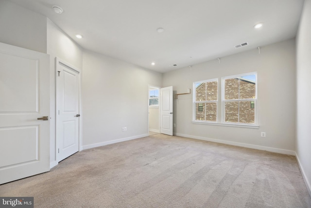 unfurnished bedroom with light carpet