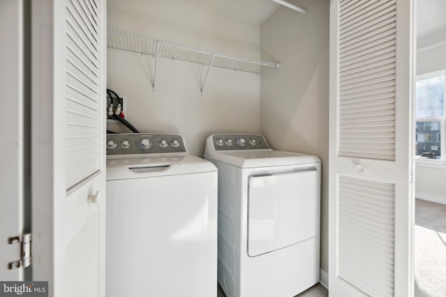 laundry area with carpet and washer and clothes dryer