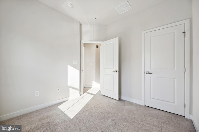 unfurnished bedroom with light colored carpet