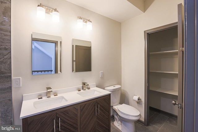 bathroom featuring tile patterned flooring, vanity, and toilet