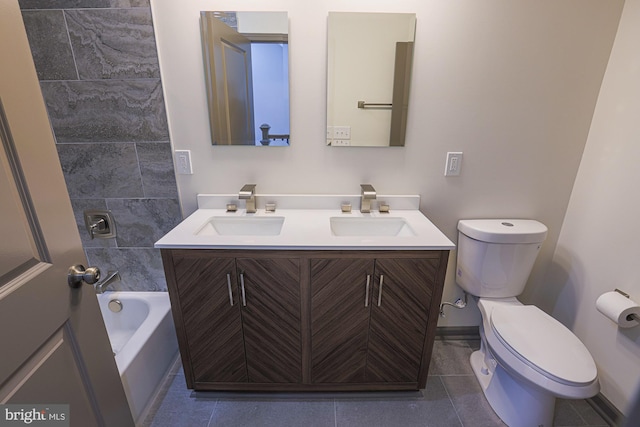 bathroom featuring tile patterned flooring, vanity, and toilet