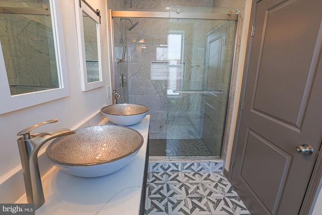 bathroom with tile patterned flooring, a shower with door, and sink