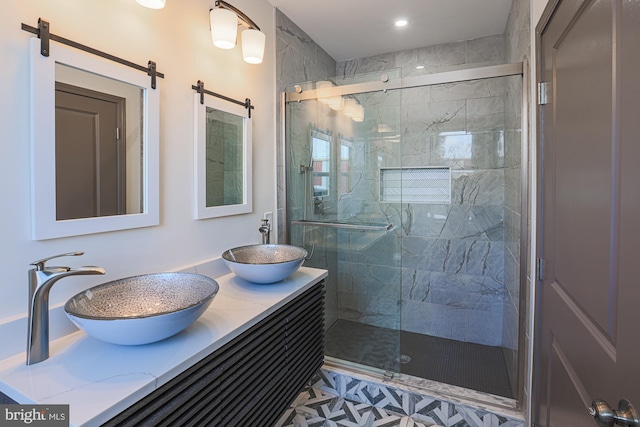 bathroom featuring vanity and a shower with door