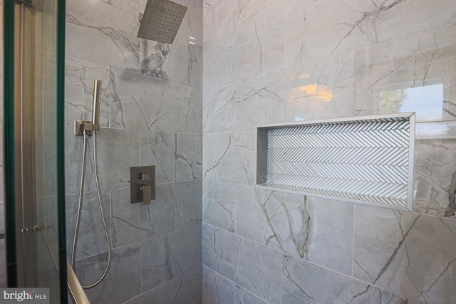 bathroom with a tile shower