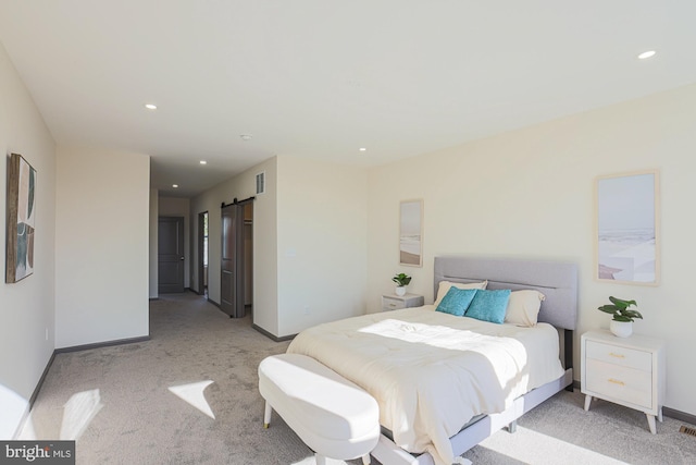 carpeted bedroom featuring a barn door