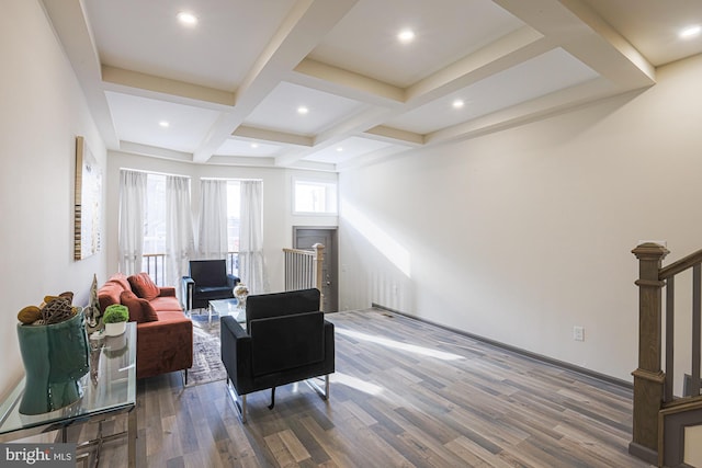 living room with beamed ceiling, coffered ceiling, and hardwood / wood-style flooring