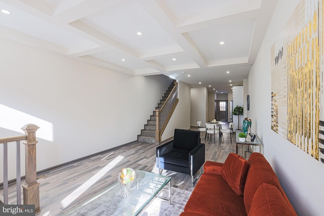 living room featuring beamed ceiling, light hardwood / wood-style flooring, and coffered ceiling