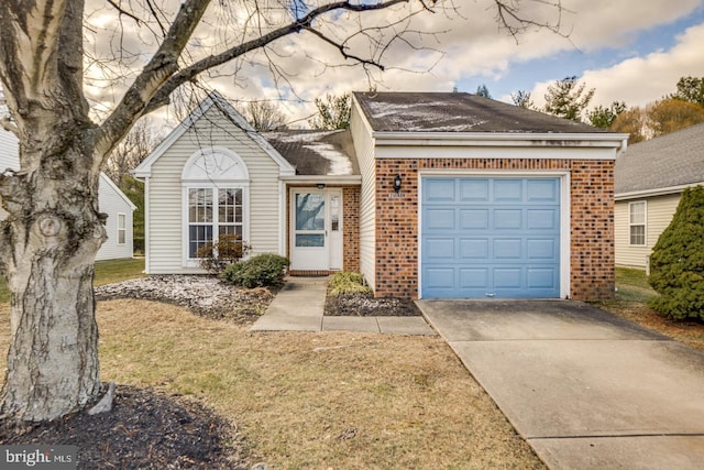 view of front facade with a yard and a garage